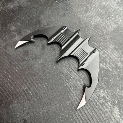 NECA BATMAN 1989 Folding Magnetic Batarang (LOOSE) displayed on a black surface, showcasing its sleek design.