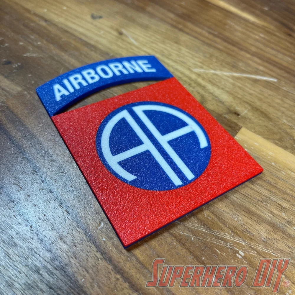 3D-printed 82nd Airborne Division display insignia on wooden surface, featuring the "AA" emblem.