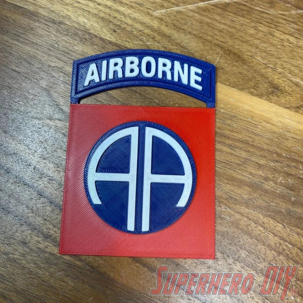 3D-printed 82nd Airborne Division display insignia on wood background