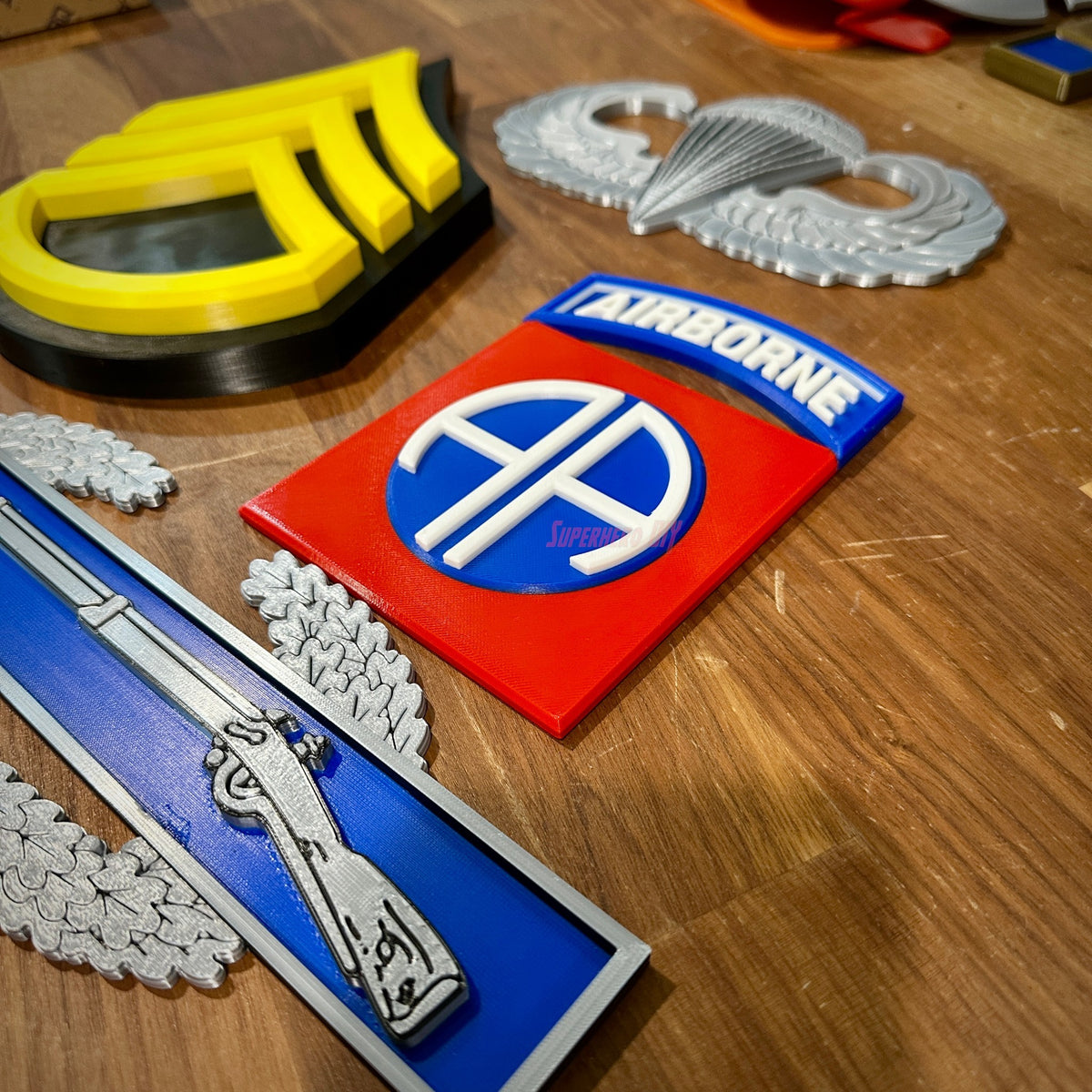 82nd Airborne Division display insignia collection featuring patches and badges on a wooden surface.