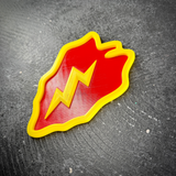 Side angle of the Tropic Lightning taro leaf insignia showing the raised yellow border and bolt in layered relief