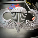 Airborne jump wings badge with detailed parachute and wings design, symbolizing parachutist achievement.