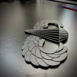 airborne jump wings badge displayed on a black surface, showcasing the detailed design of the badge.