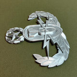 Replica EOD Badge Display in silver, showcasing intricate design on green background, symbolizing military technical skill.