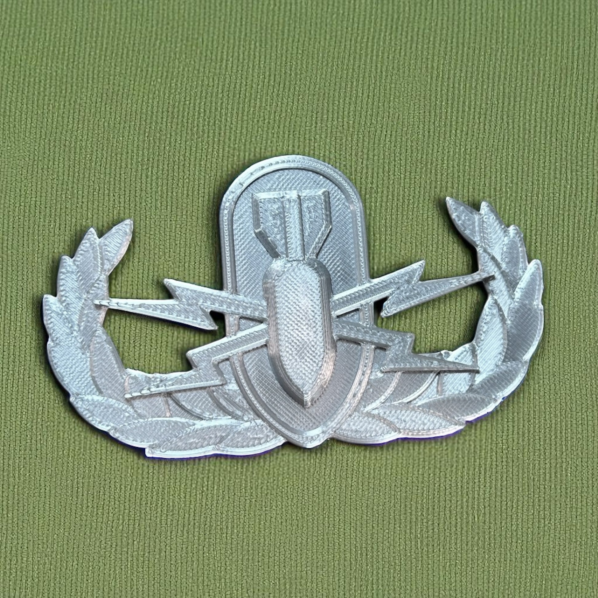 Replica EOD Badge Display on a green background showing technical skill and military achievement.