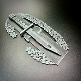 Combat Action Badge display insignia with pewter finish and knife design, ideal for wall or desk display.
