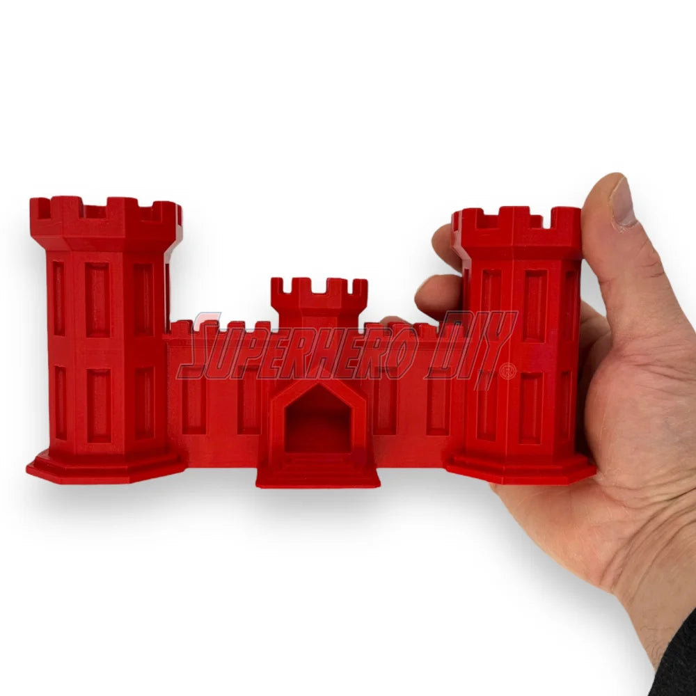 3D-printed red Army Engineer Castle held in hand, representing U.S. Army Corps of Engineers symbol for combat engineers and veterans.