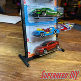 Display of 1:64 scale cars on a stand, featuring the hot wheels wall display sleeve for showcasing blister-packed vehicles.