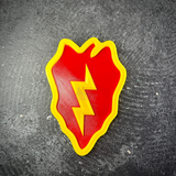 Close-up of the 25th Infantry Division Tropic Lightning insignia, yellow bolt down the center of the red leaf