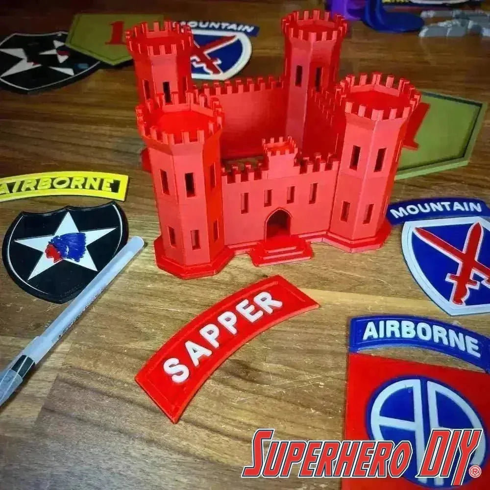 Engineer Corps Castle display with SAPPER tab and military patches on a wooden surface
