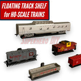 Floating HO-scale train display shelf with colorful train cars and track design for showcasing models.
