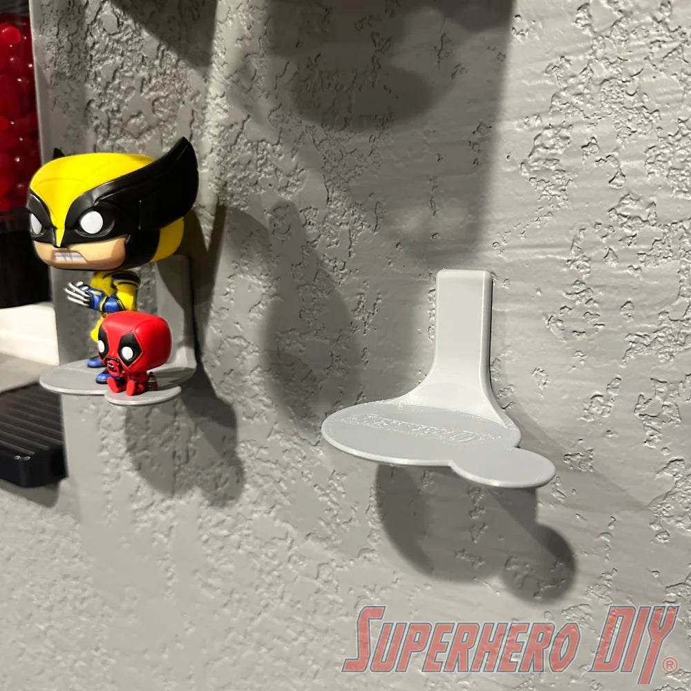 Wall-mounted display shelf for Funko Pop & Buddy figures, showcasing two figures on textured wall.