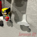 Wall-mounted display shelf for Funko Pop & Buddy figures, showcasing two figures on textured wall.