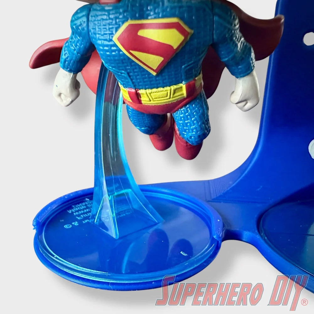 Blue floating shelf with clear support stand holding Superman Funko Pop figurine. - SuperheroDIY