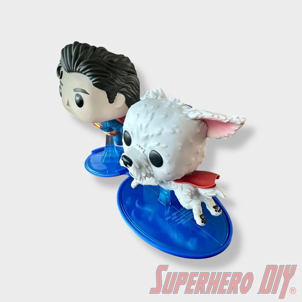 Blue floating shelf holding Superman and Krypto Funko Pop figures with clean edges. - SuperheroDIY