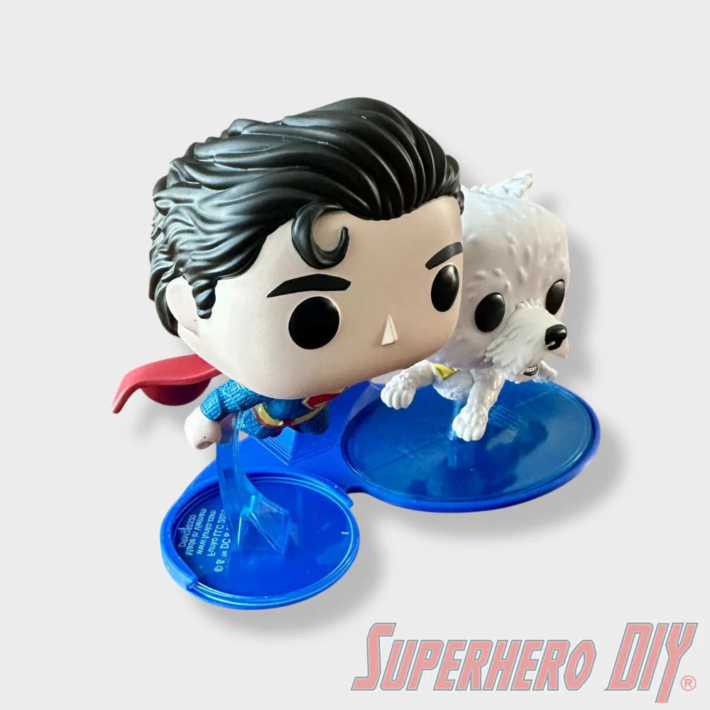 Blue floating shelf display holding Superman and Krypto Funko Pop figures with curved edges. - SuperheroDIY
