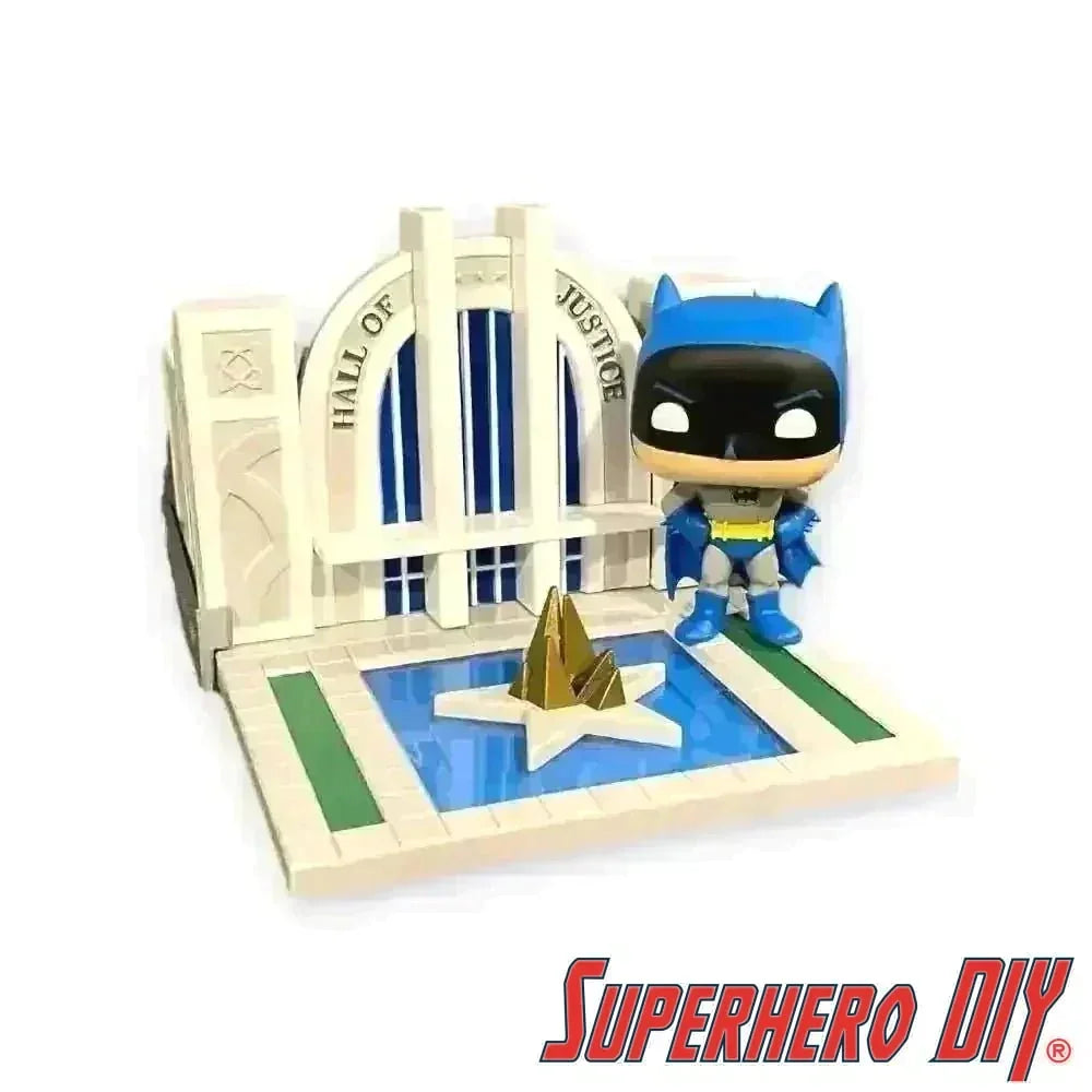 Hall of Justice floating shelf with Batman Funko Pop! in front of superhero-themed backdrop.