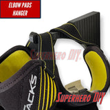 Wall-mounted hockey gear organizer featuring elbow pads hanger for easy storage and access.