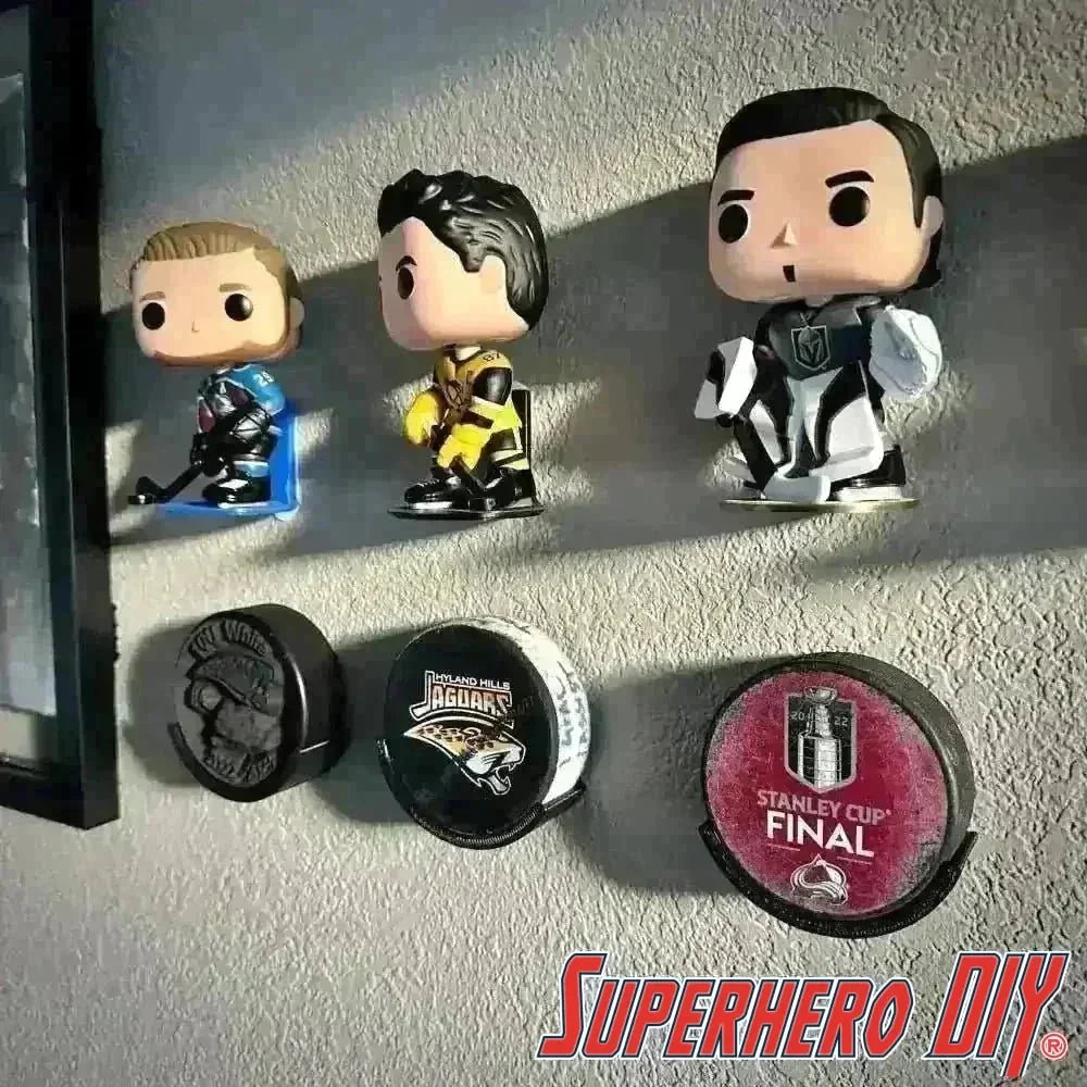 Hockey Puck Display Case Holder Wall Mount with decorative figures and pucks illustrating sports memorabilia display solution.