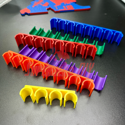 Colorful wall-mount dry erase marker holders in yellow, red, purple, green, and blue, each with multiple slots. - SuperheroDIY