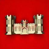 3D-printed model of the Army Engineer Castle symbolizing the U.S. Army Corps of Engineers, set on a red background.