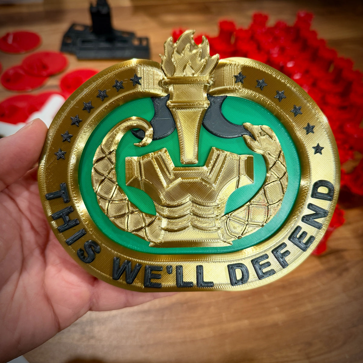 Drill sergeant bad in gold and green with black lettering, held in hand. This is the 6” wide version