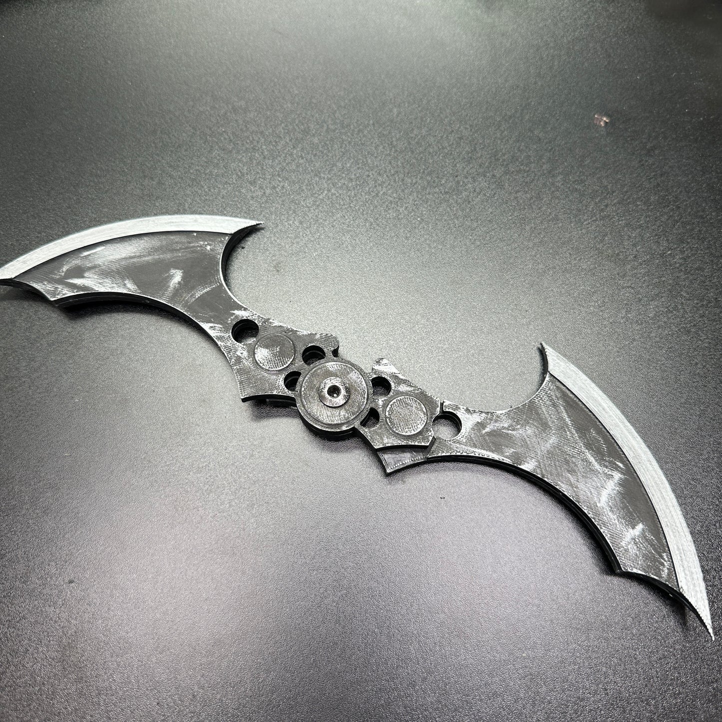 MAGNETIC Folding Arkham Batarang Cosplay Prop - 10" version with neodymium magnets, opened on black surface for display.