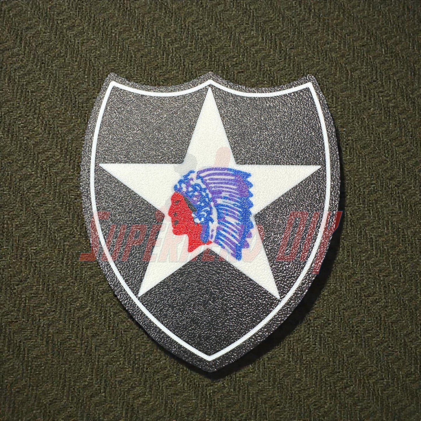 3D-printed 2nd Infantry Division display insignia patch on textured background.