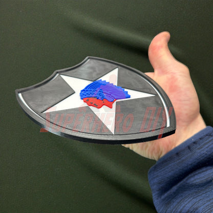 Person holding a 3D-printed 2nd Infantry Division display insignia, showcasing the design for shadowboxes or wall displays.