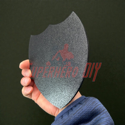 Person holding a 3D-printed 2nd Infantry Division display insignia in hand, black shield shape, available in multiple sizes for display.