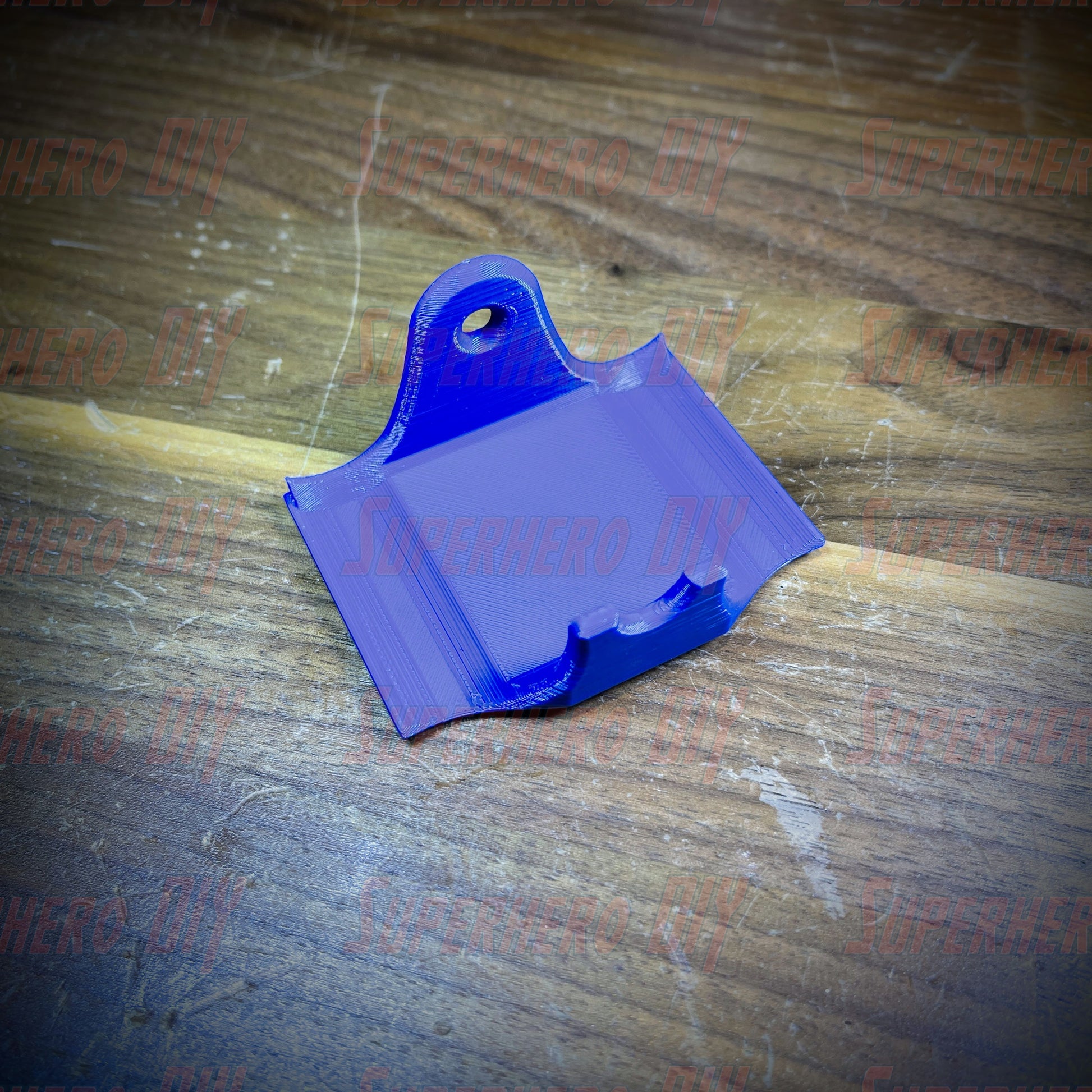 Blue PS4 controller wall mount for DualShock, includes command strip for easy installation, keeps gaming area organized.