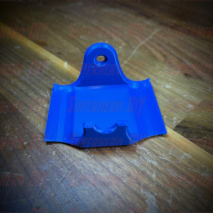 Blue PS4 controller wall mount on wooden surface, fits DualShock, includes Command Strip for easy installation.