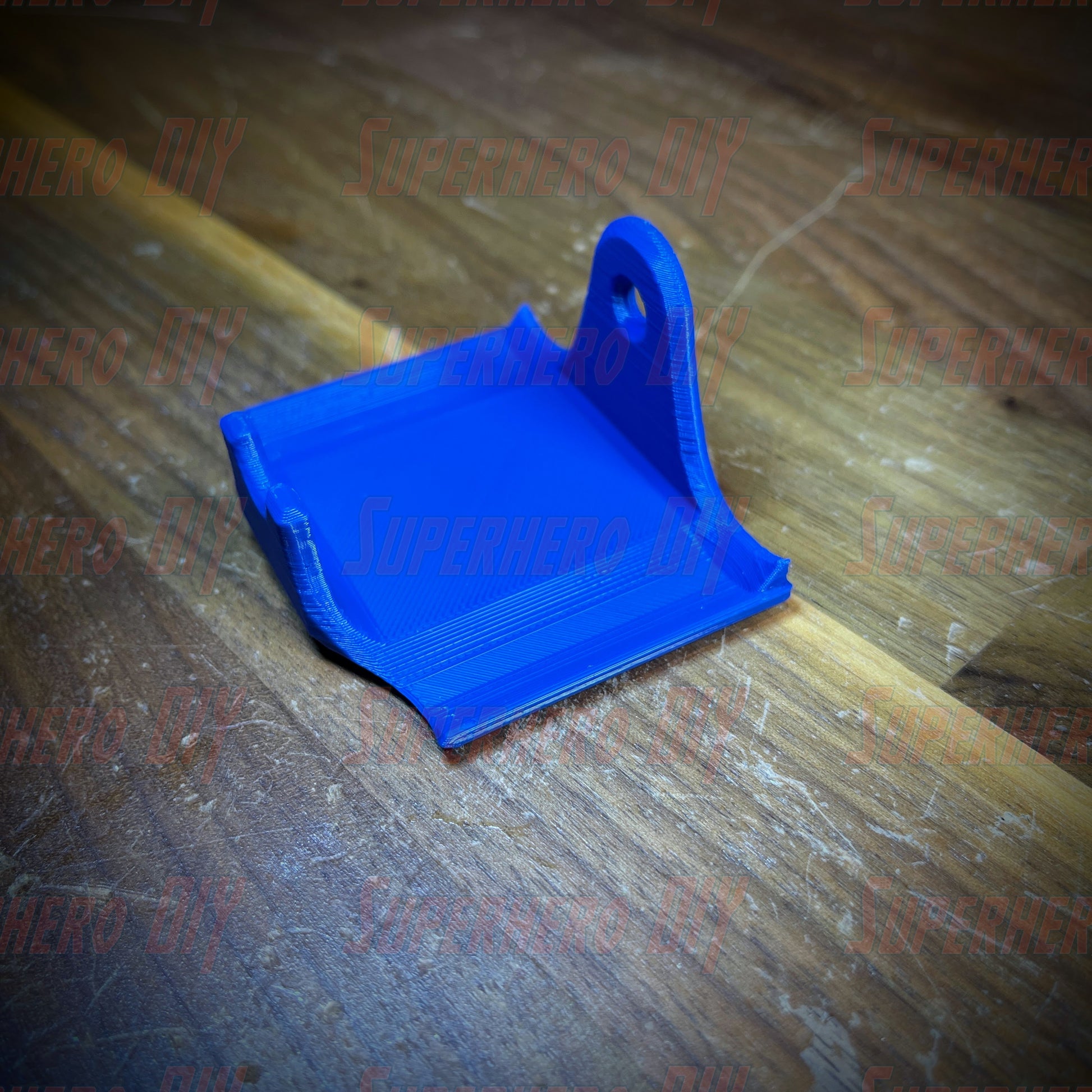 Blue PS4 controller wall mount for DualShock with command strip included, perfect for organizing gaming setup.