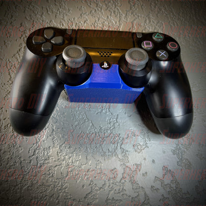 PS4 controller wall mount with DualShock 4 attached, easy access and organization, includes Command Strip for secure installation.