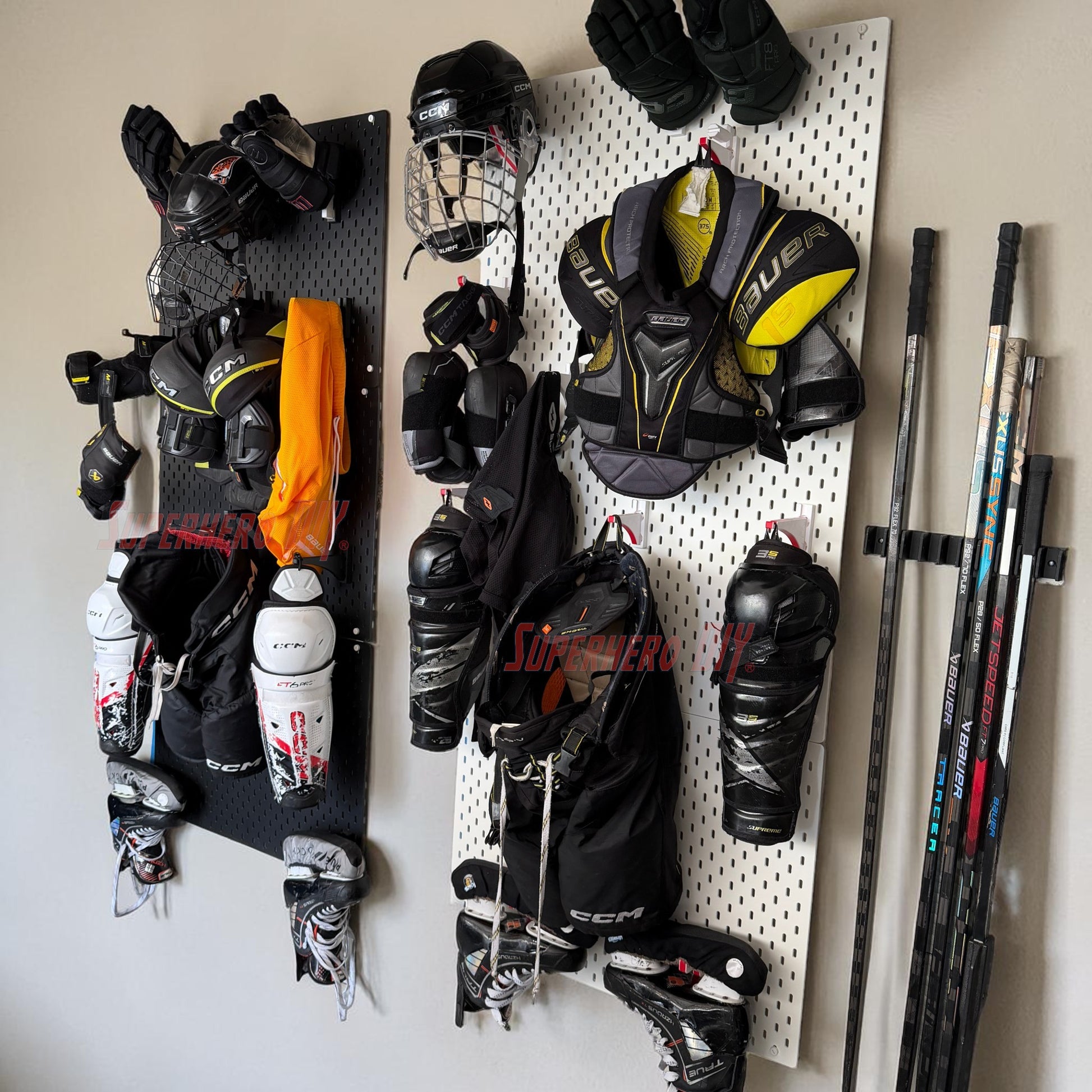 Hockey equipment including gloves, masks, and skates hanging on a pegboard.