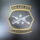 3D Bradley Master Gunner Badge display insignia featuring crossed weapons and stars.