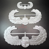 Air Assault Badge display featuring multiple wings in shiny silver finish on a black background.
