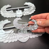 Air Assault Badge display with shiny silver finish, showcasing military insignia in hand.