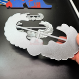 Air Assault Badge display piece in shiny silver finish held by hand for military insignia showcase.