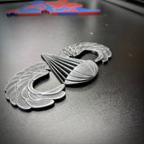 Airborne badge jump wings displayed on a black surface, representing achievement and courage.