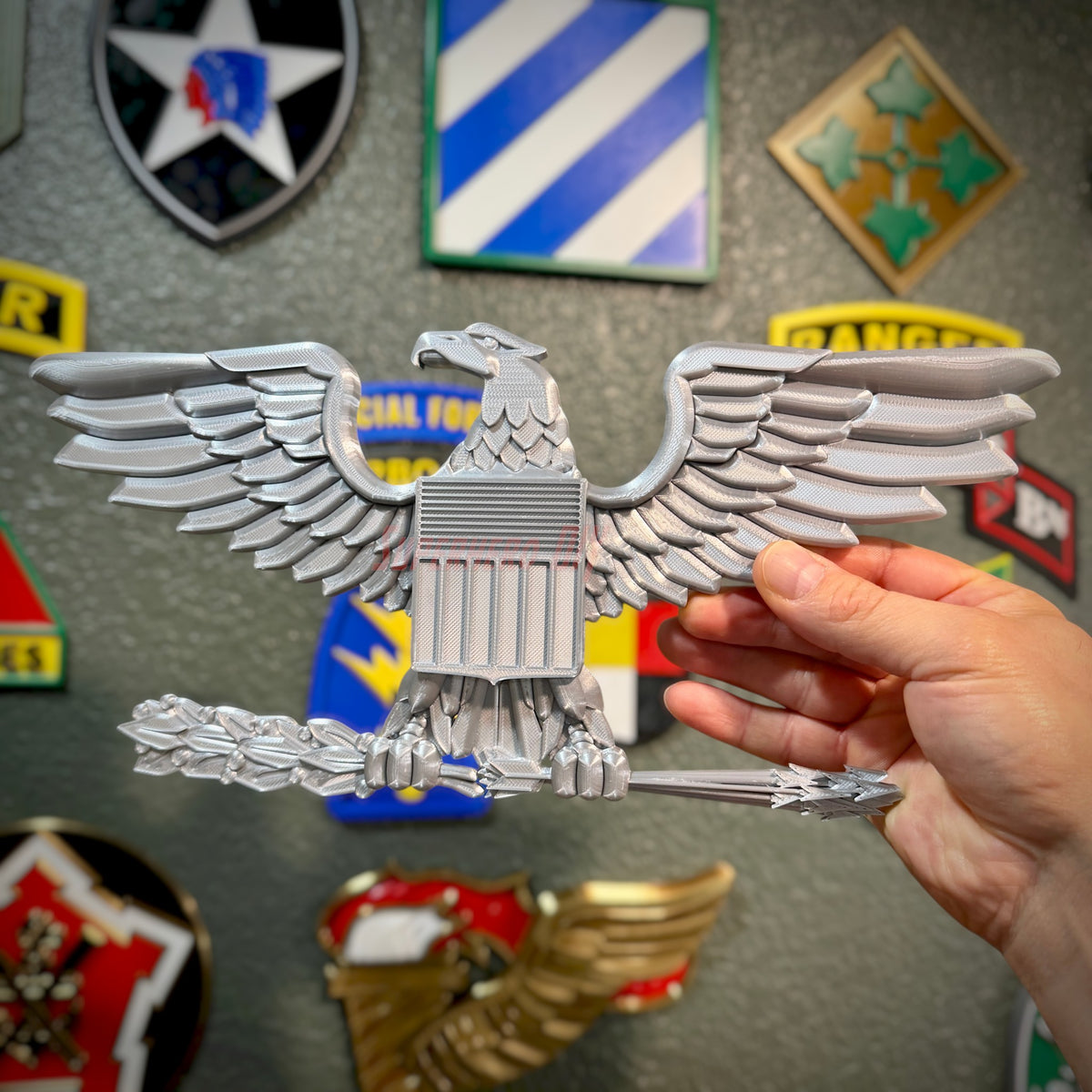 Colonel O-6 Navy Captain rank insignia replica held by hand, showing intricate eagle design and glossy finish.