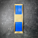 Navy WO1 insignia in gold and blue, displayed on a black concrete floor.