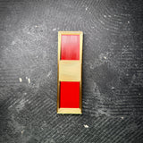 USMC WO1 rank insignia in gold and red, displayed on a black concrete background.