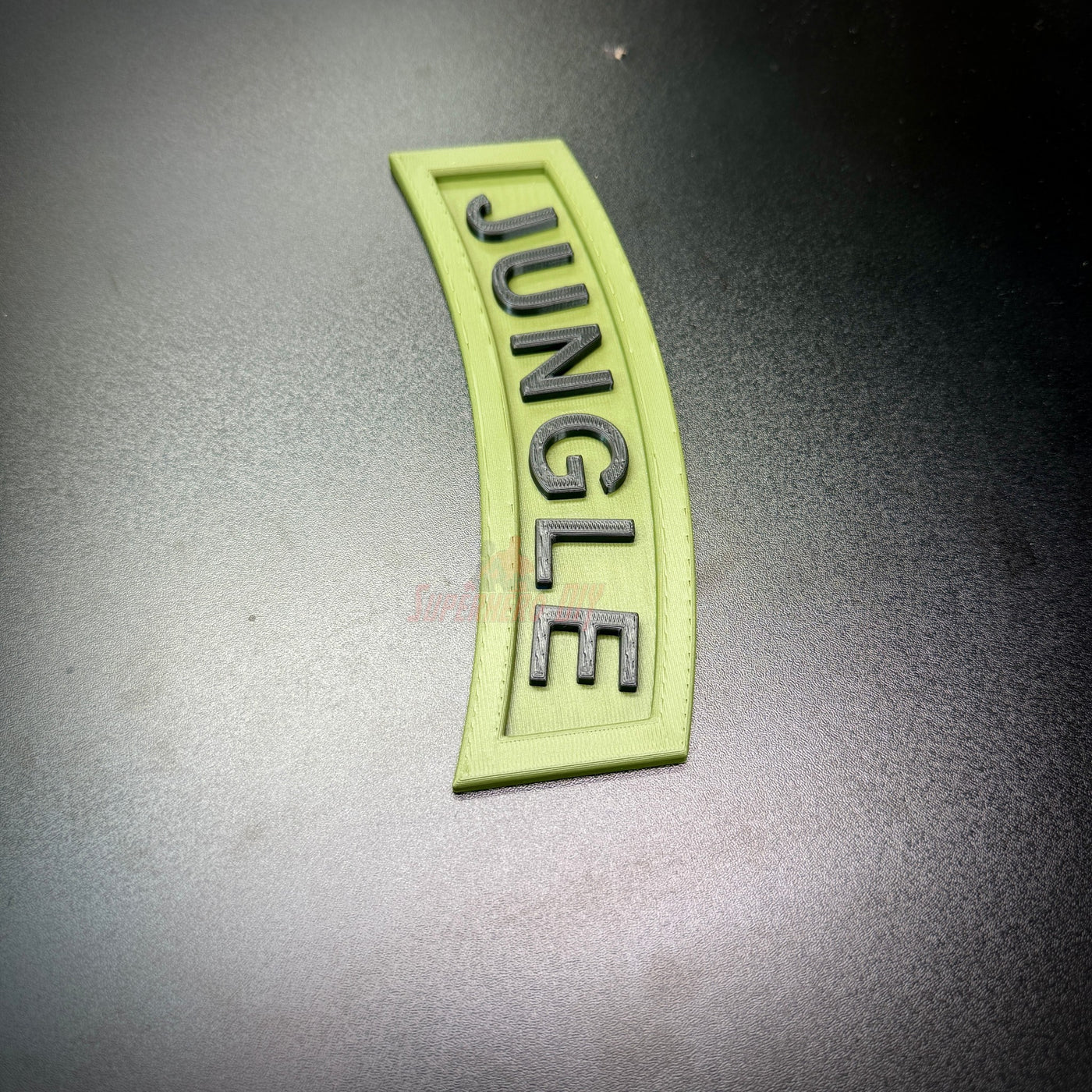 3D Jungle Tab in army green with black lettering, a decorative display piece for wall decor.