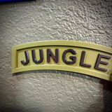 JUNGLE lettering on a wall-ready jungle tab display piece with an army green background.