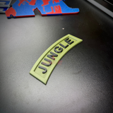 3D Jungle Tab display piece in army green with black JUNGLE lettering on a black surface.
