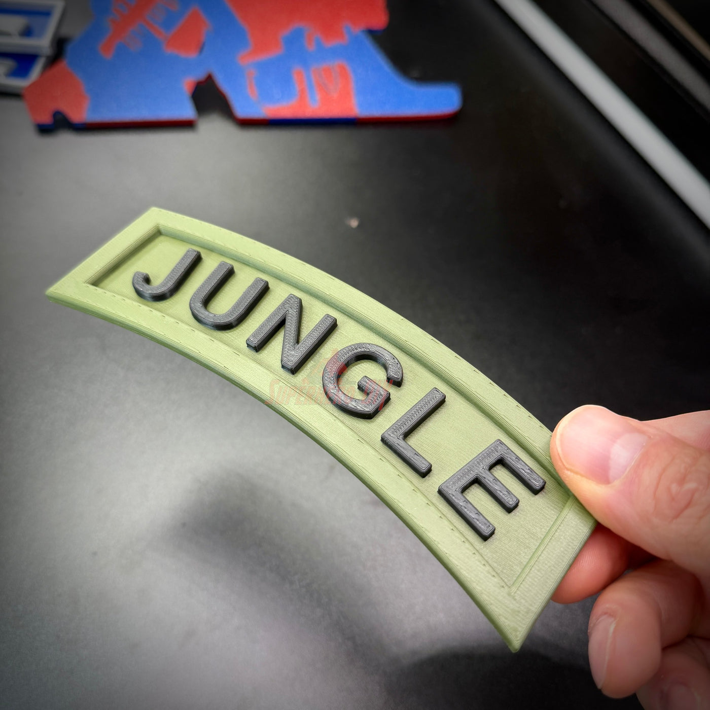 3D jungle tab display piece in army green with raised black lettering, perfect for office or shadow box decor.