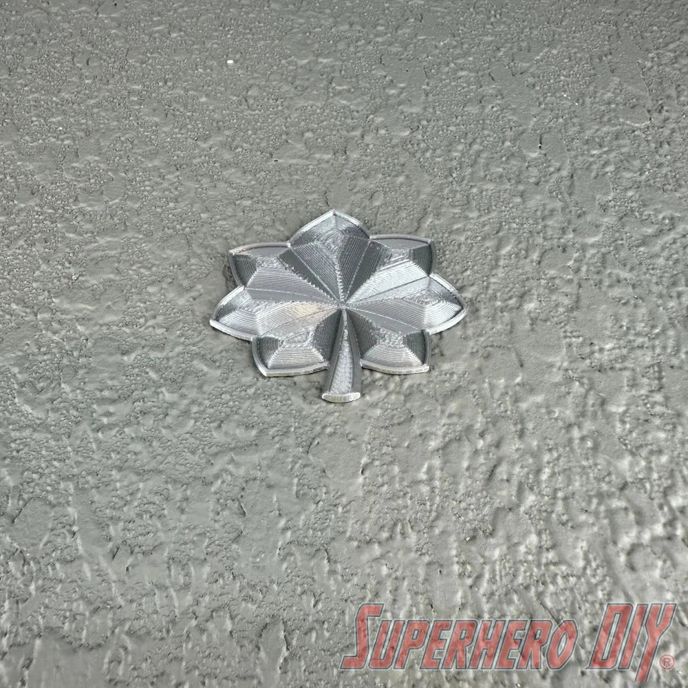 Lieutenant colonel rank insignia in shiny silver finish against a textured background.