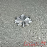 Lieutenant colonel rank insignia in shiny silver finish against a textured background.
