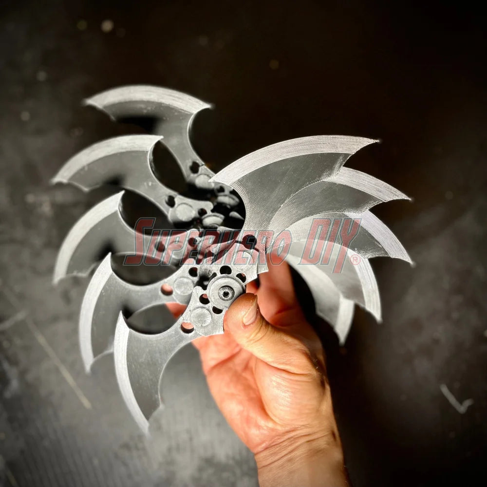 Hand holding MAGNETIC Folding Arkham Batarang Cosplay Prop - 10" version with metallic blades, ideal for themed cosplay displays.
